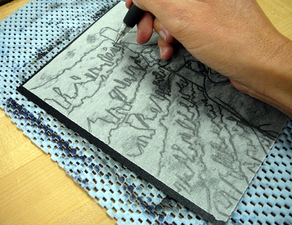 a hand drawing on a thin sheet of paper laid on top of an inked plate with a technical pencil