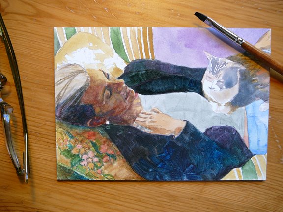 a watercolor of a woman reclining with a cat on her torso in process