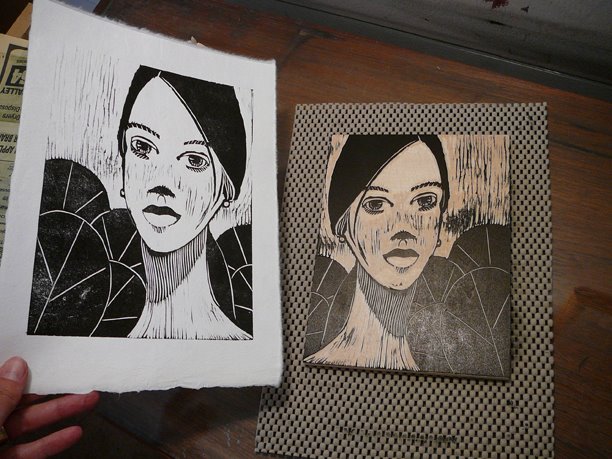 a manga style woodcut print portrait in process, with a woman's face, and pond lily leaves behind her