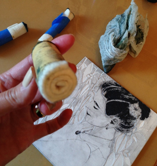 a craft felt dauber made by rolling two inch strips of felt and securing them with masking tape to use as an ink applicator in printmaking