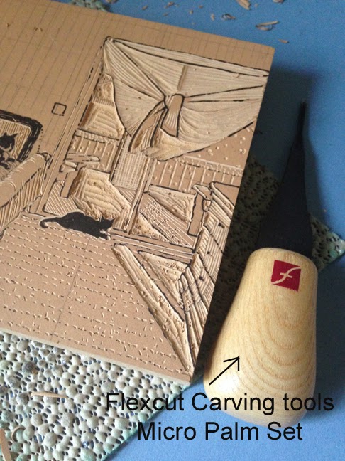 a block in process and a knife nearby with the flexcut logo on the handle