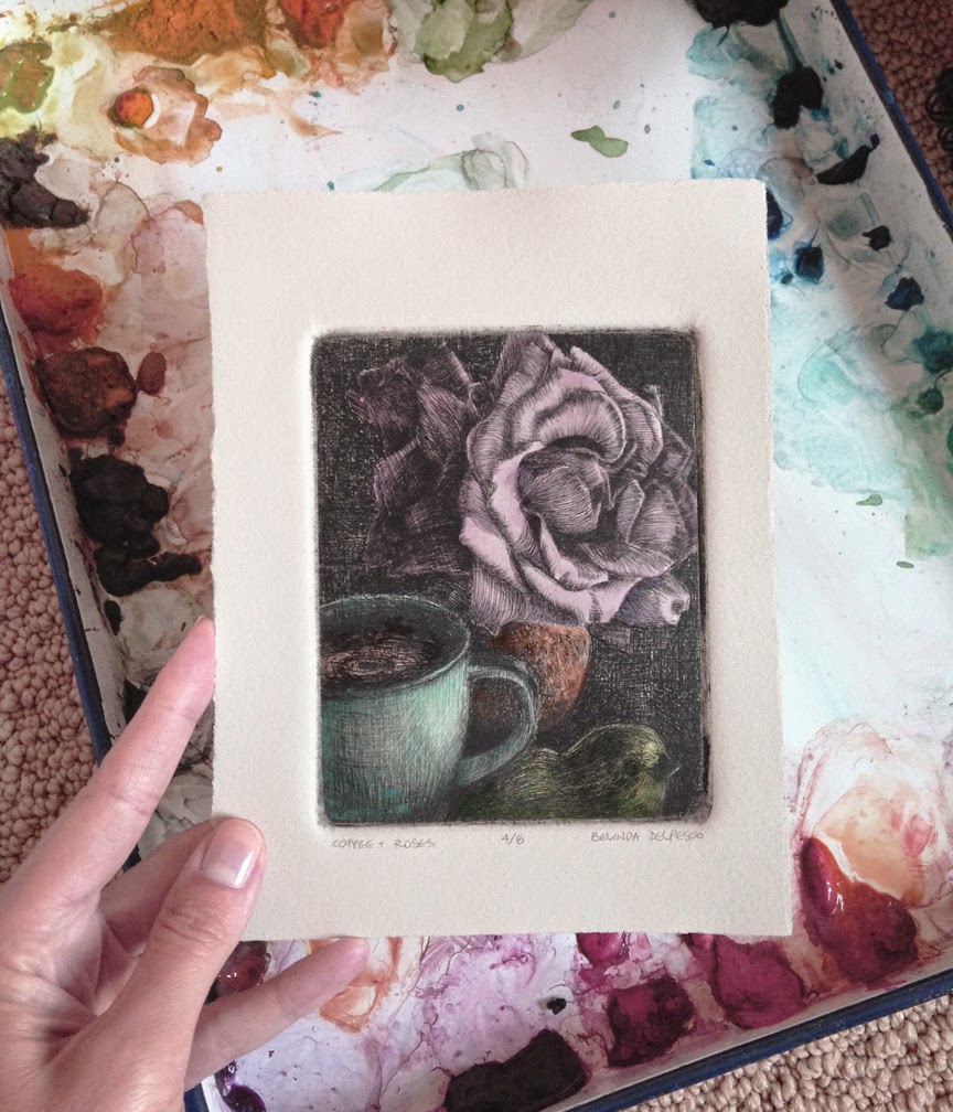 a drypoint print of a rose, a mug and a bird figurine from a sheet of plexiglass, painted with watercolors