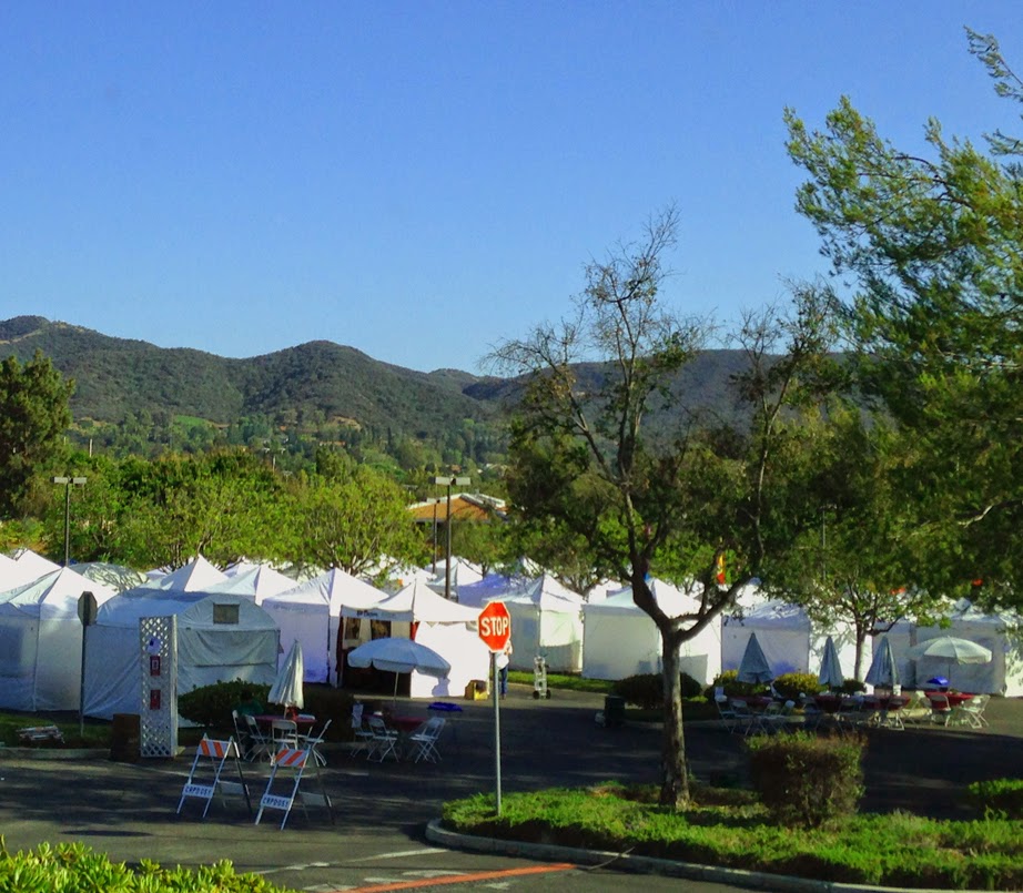 a row of artist's tents at an art festival in thousand oaks, california