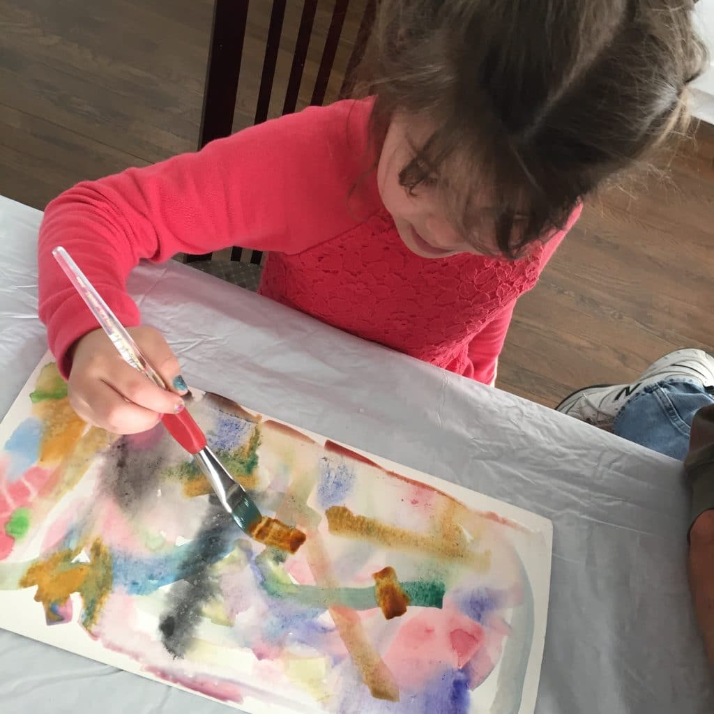 a child painting with watercolors