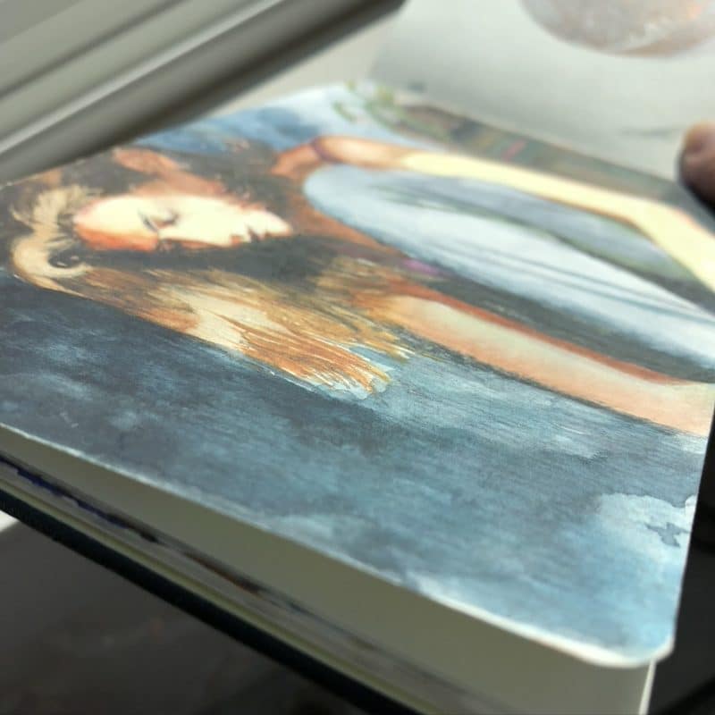 a figurative watercolor painting in a moleskine sketchpad