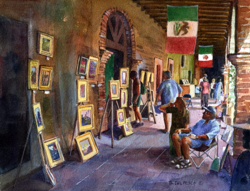 a painter displaying his oil painting in an arcade at the San Juan Capistrano Mission