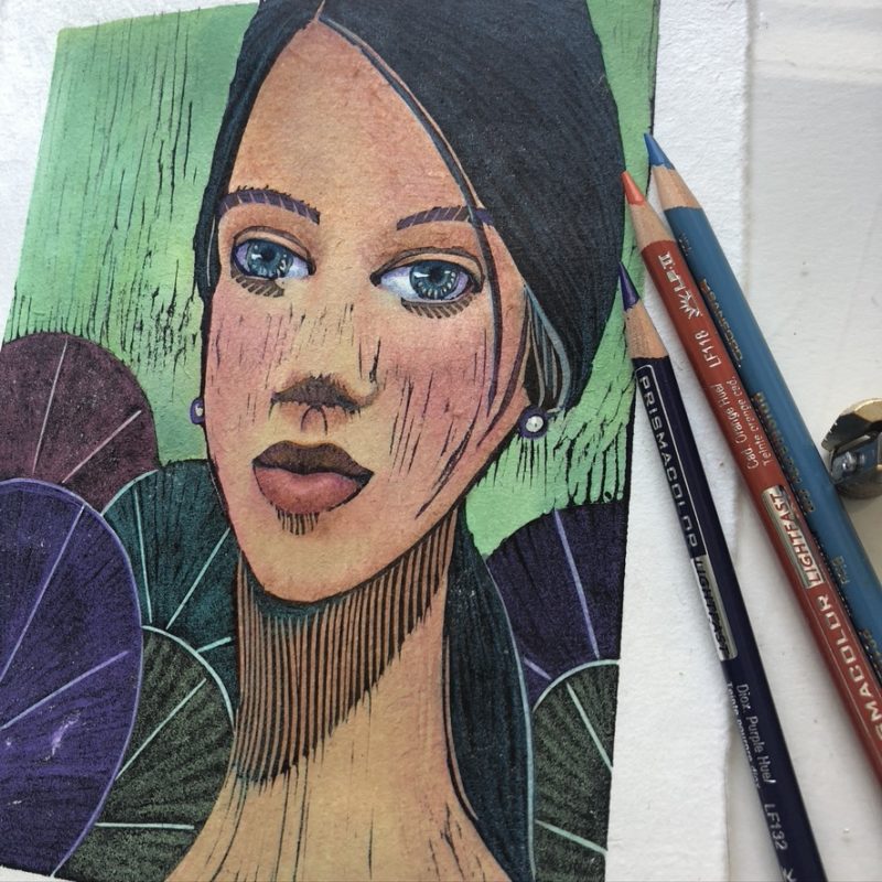 a manga style woodcut print portrait in process, getting some colored pencil added, with a woman's face, and pond lily leaves behind her