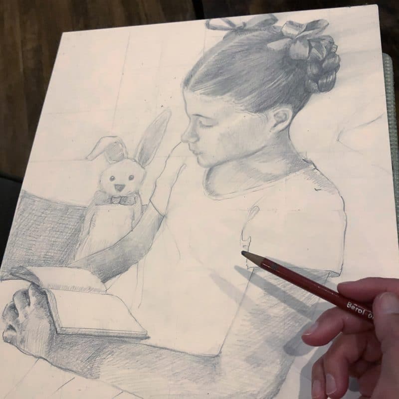 a pencil drawing of a little girl with a book in her lap and a bunny standing by