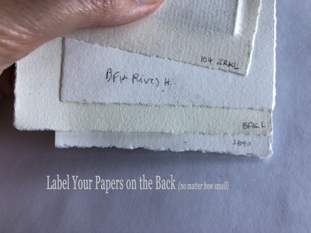 Assorted printmaking papers marked in pencil on the rear to keep track of manufacturer and weight
