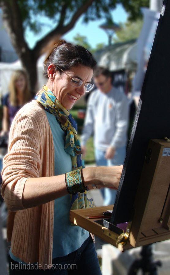 Belinda Del Pesco painting a watercolor at an art festival