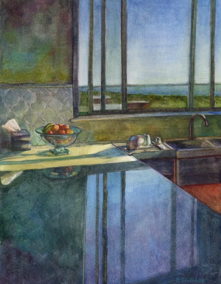 a kitchen counter with a window in the background throwing reflections of the sky across the countertop