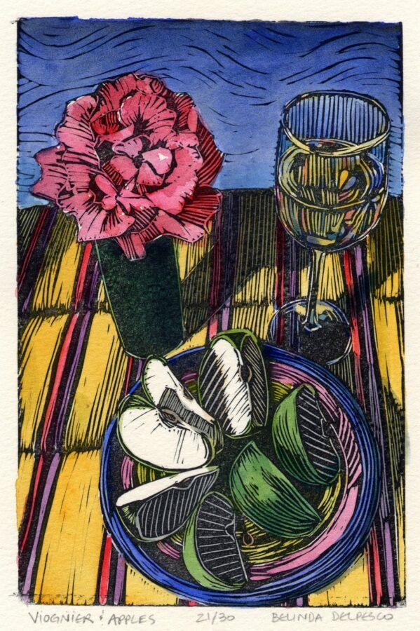 linocut still life of sliced apples, a rose and a glass of white wine on a striped plate and table cloth